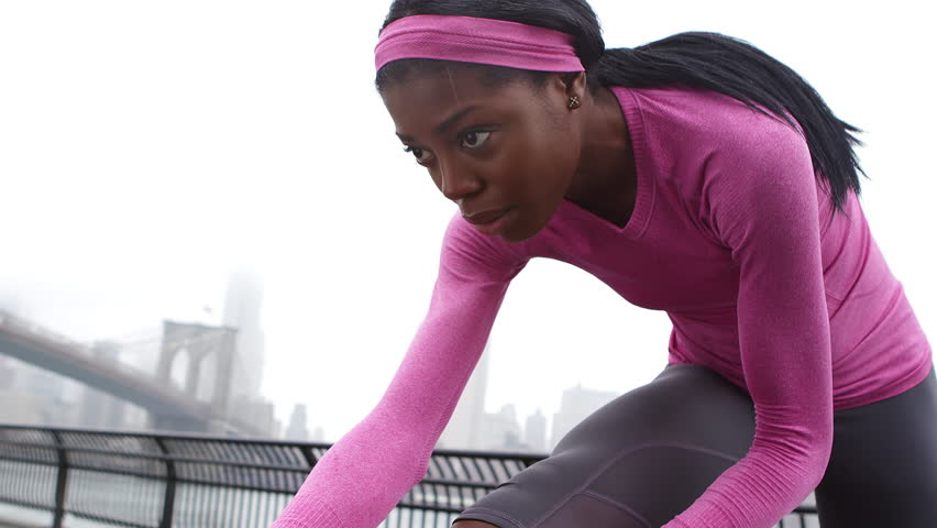 A Woman Stretches Before a Run