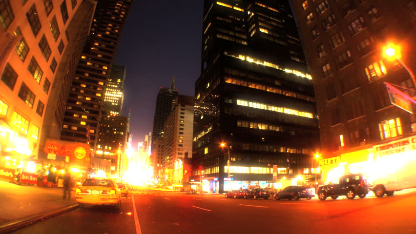 Night time-lapse w/fish-eye of traffic & lights on Broadway, New York City, USA