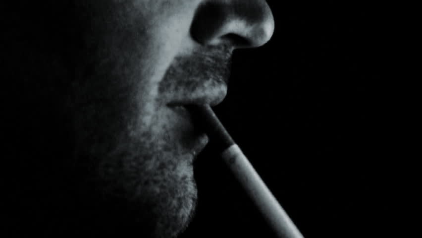 Man smoking and coffin