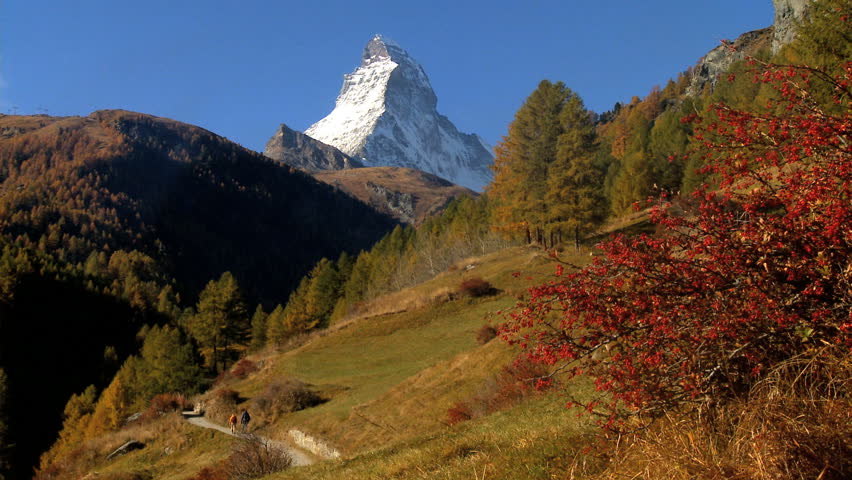 Fall in an alpine meadow, Zermatt, with hikers & the Matterhorn, motion jib