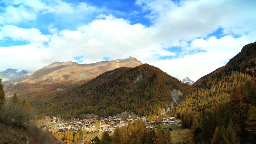 Time-lapse clouds over Zermatt village in alpine meadow at the base of Matterhorn, Switzerland