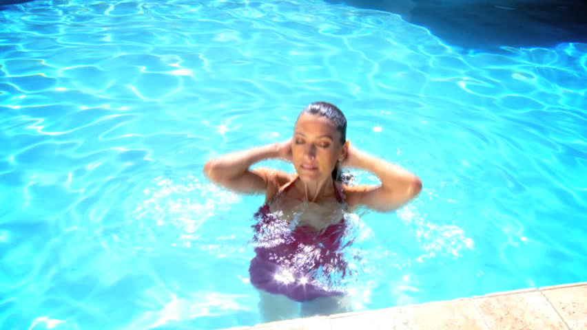Attractive young caucasian female enjoying leisure time in her swimming pool 60 FPS