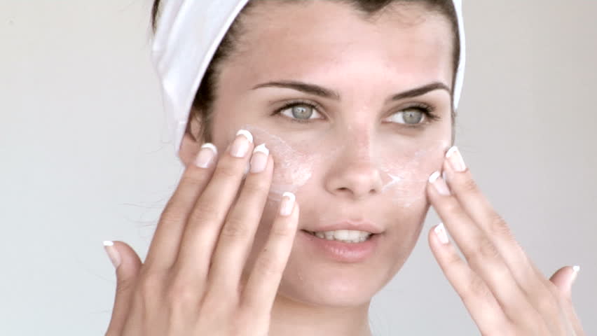 Closeup of a woman applying cream