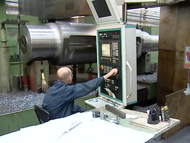 A man works on a lathe