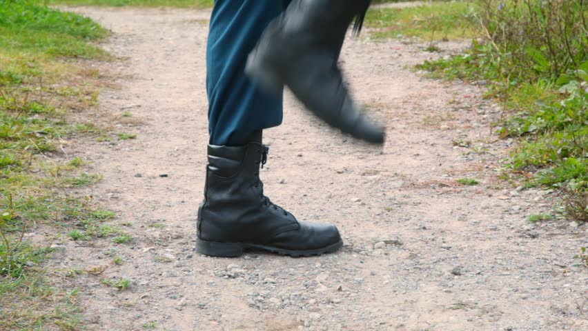 soldier in military boots march on the spot, close up, profile 