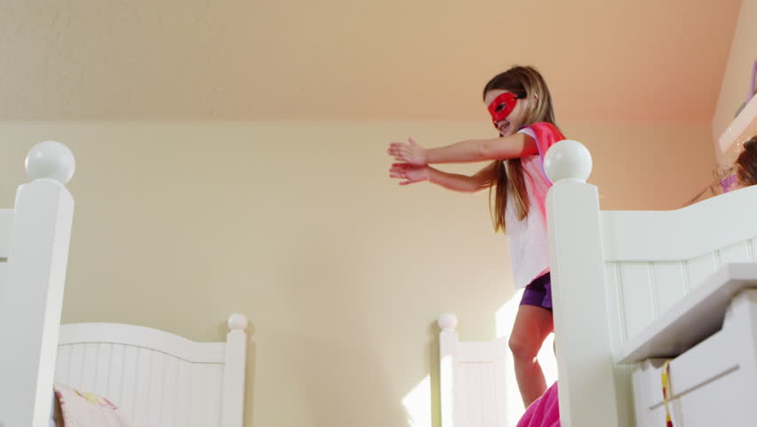 Young girls dressed as superheroes playing at home - 4K