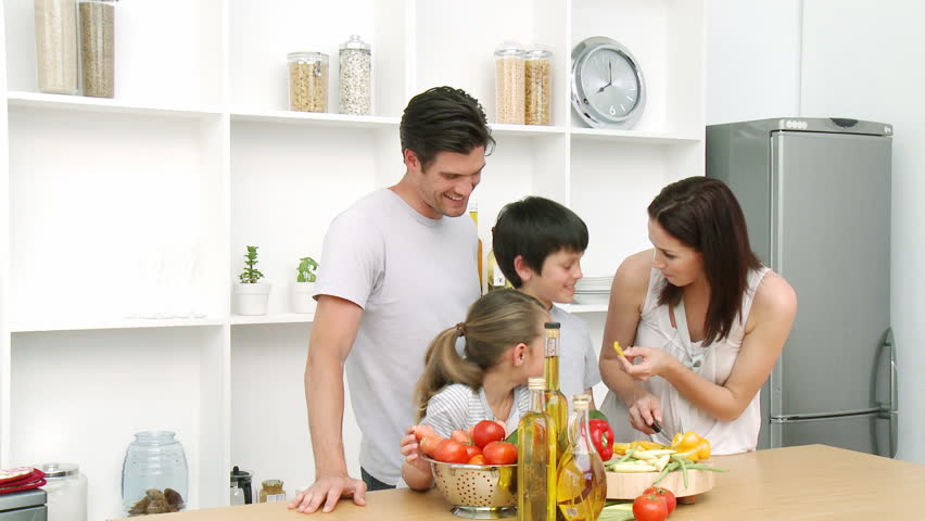 Family at home in Kitchen Preparing Lunch and having a good time