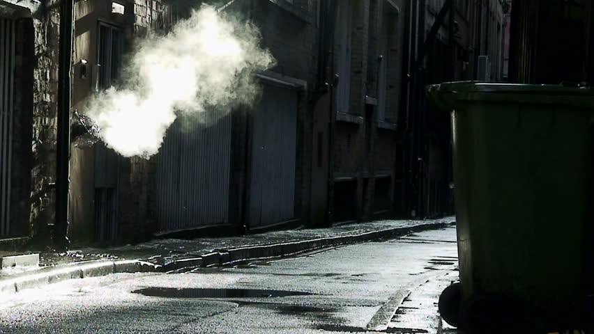 Steam coming from outlet in dirty, dark back alley