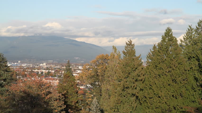 Pan of Vancouver, BC Skyline with Mountains