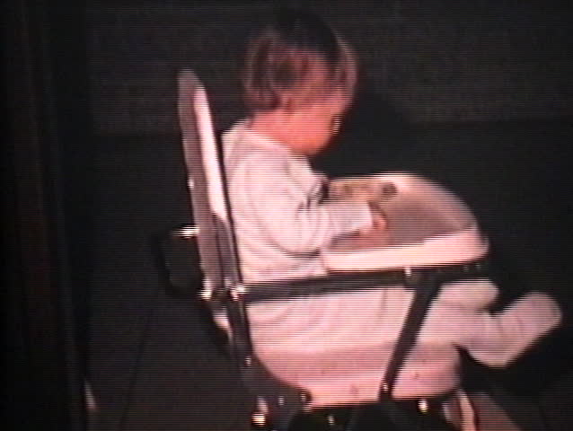 A little girl tries to avoid the harsh bright light from the 8mm camera her daddy is using. (Vintage 8mm film)