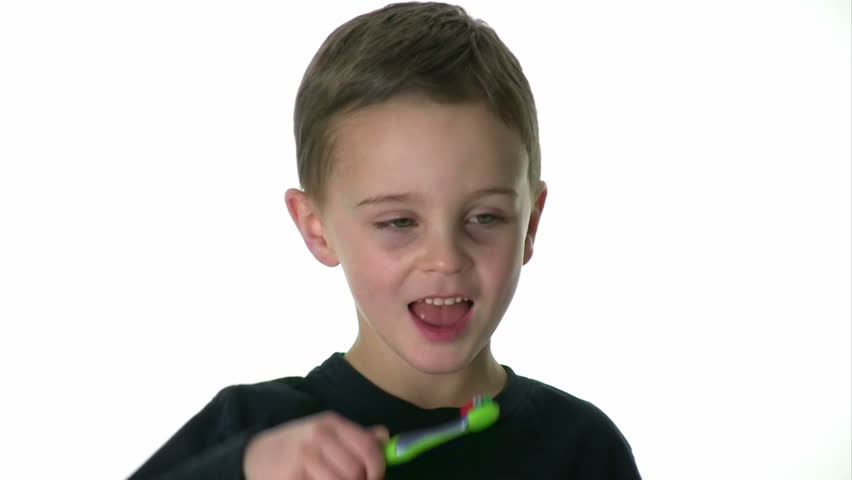 Kid brushes his teeth.  White background.