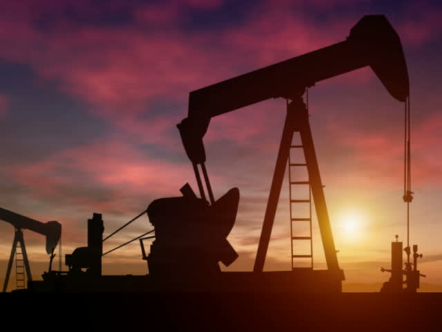 Oil rigs pump as the sun sets behind them. Digitally generated and seamlessly loopable. PAL