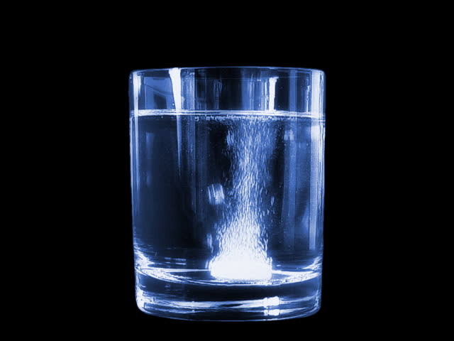 Sparkling tablet dropped into the glass of water