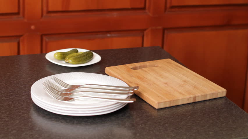 woman lays down meal on plates. 