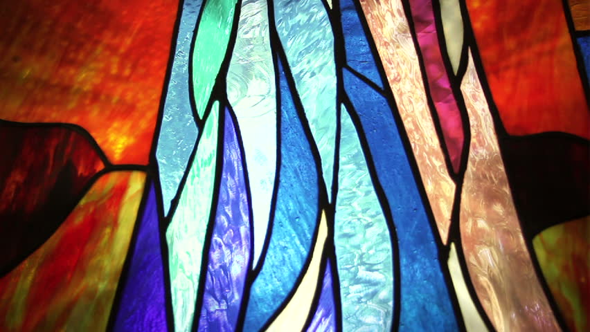 Seamless Loop Background Stained Glass window changing color with a motion glow behind it.