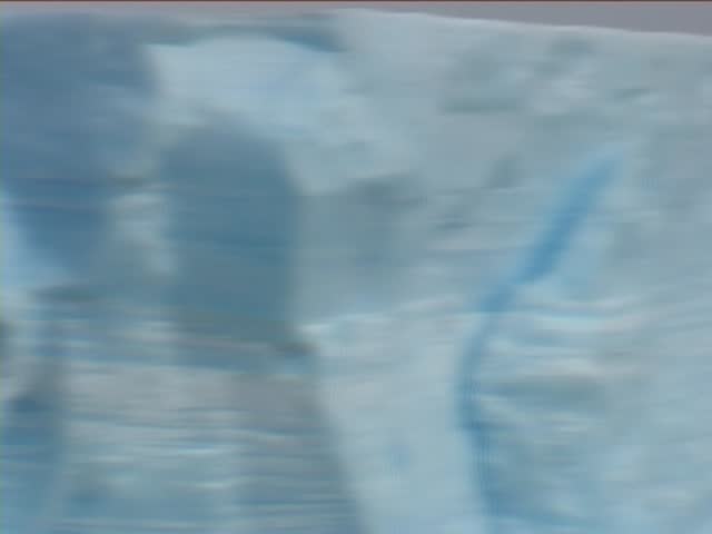 Beautiful Antarctic Iceberg moving fast with Time Lapse. Zooming out and panning. Taken from a passenger cruise ship.