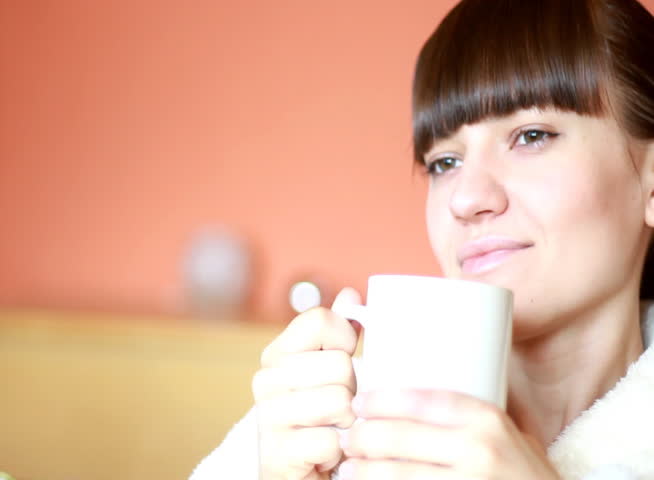 Young woman in bahtrobe drinking tea - NTSC