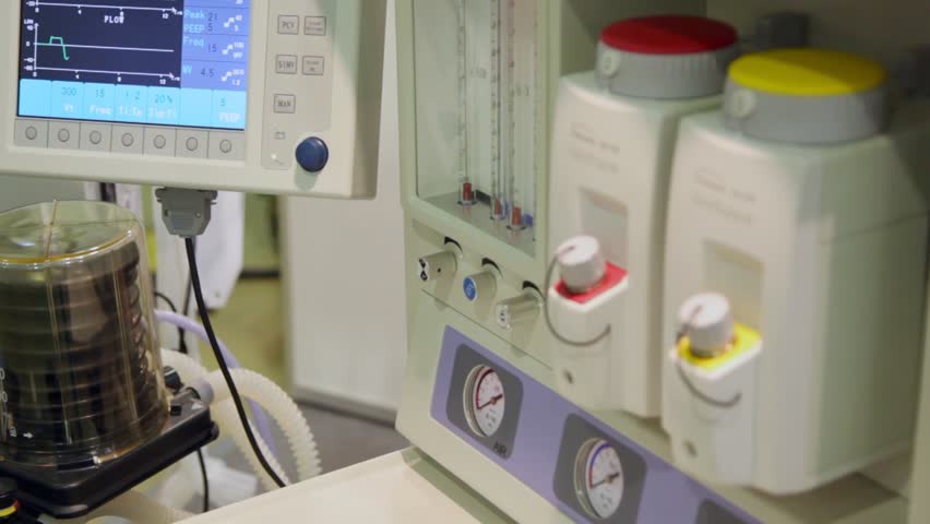 volume ventilator, pump in flask, tubes, gauges and monitor close up 