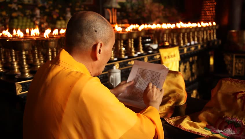 LESHAN, CHINA - AUGUST 24: Buddhist monks performing ceremony inside Baoguo monastery, Leshan, Sichuan, China, August 24, 2009