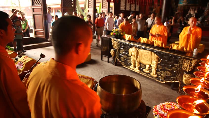LESHAN, CHINA - AUGUST 24: Buddhist monks performing ceremony inside Baoguo monastery, Leshan, Sichuan, China, August 24, 2009