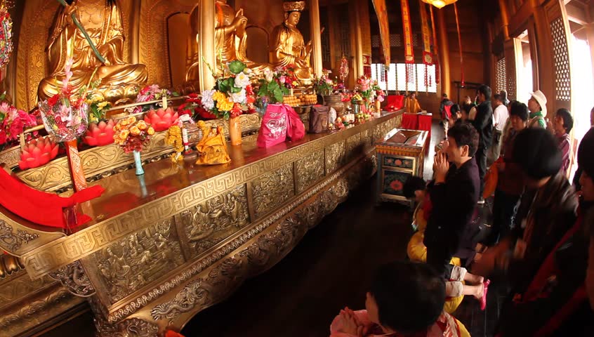 SHANGHAI, CHINA, - Buddhist visitors pray and light incense to practice their belief at Jade Buddha Temple (Yufo Si) - Shanghai, China, July 08, 2009
