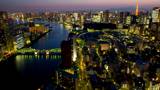 Traffic streaks through-out frame in wide shot of Tokyo, Japan, time-lapse