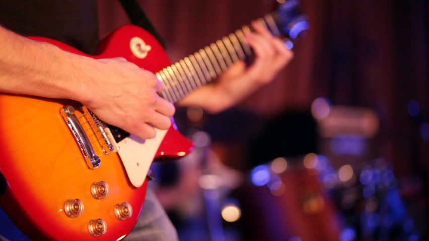 musician plays a guitar