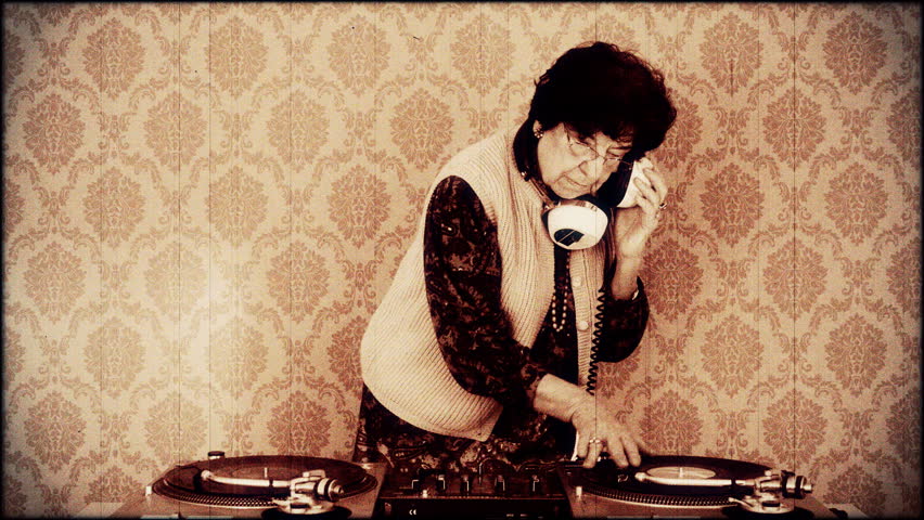  a very funky elderly lady dj, spinning records!! with aged film look
