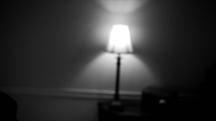The camera tilts down from a small lamp to reveal a man wearing a fedora and typing on a vintage 40's typewriter. Film Noir,