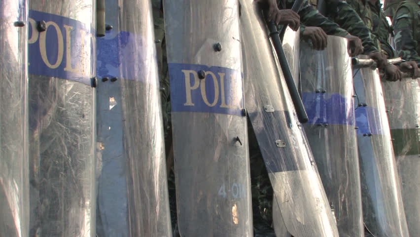 Police with riot shields and clubs