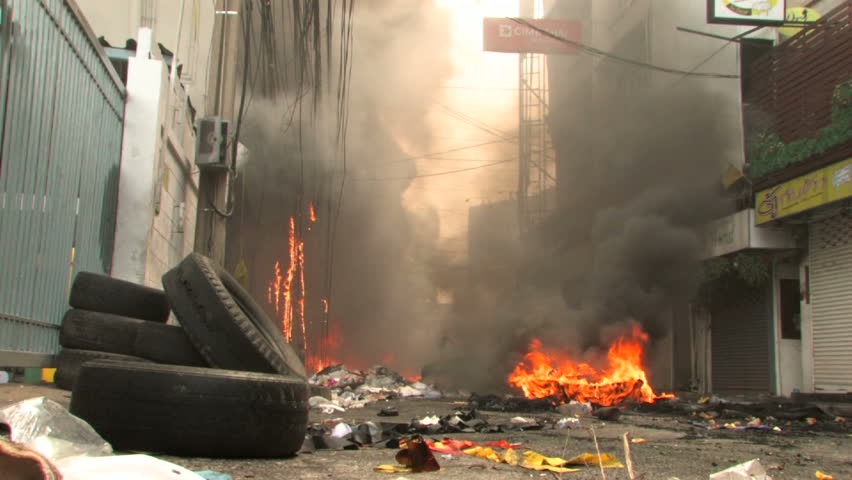 BANGKOK, THAILAND - April 19, 2010: Firemen battle blazes across the city after protesters set more than 40 buildings on fire during a government crackdown 