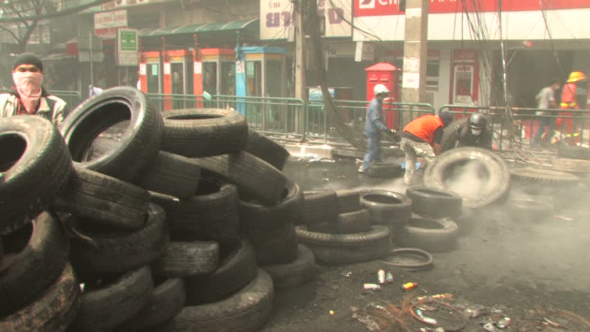 BANGKOK, THAILAND - April 19, 2010: Protesters build barricades built of tires to create smoke screens seeking protection from government snipers 