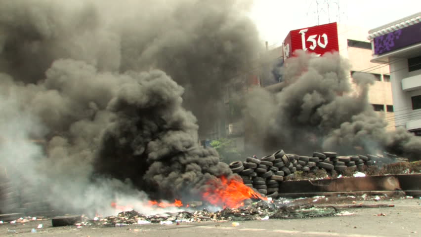 BANGKOK, THAILAND - April 19, 2010: Protesters build barricades built of tires to create smoke screens seeking protection from government snipers 