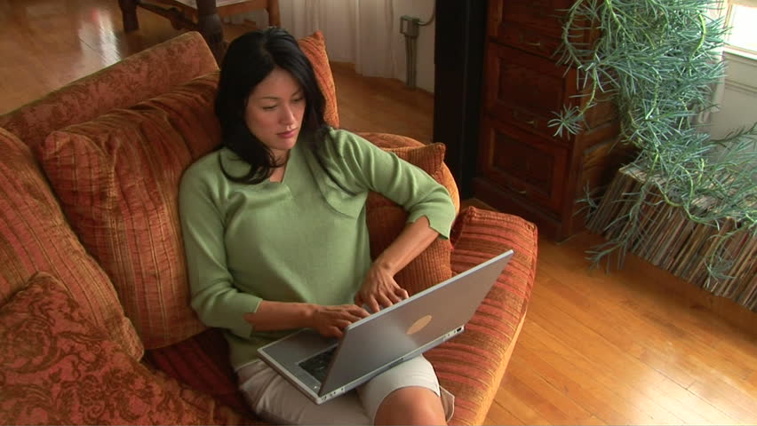 Young woman using laptop on couch