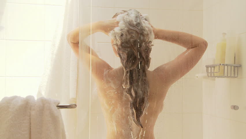 Woman washing hair in shower