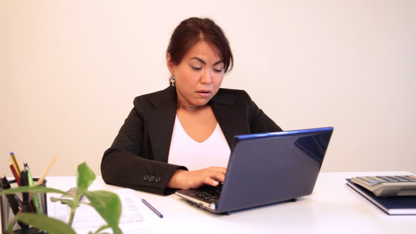 Businesswoman gets terrified after reading bad news on laptop