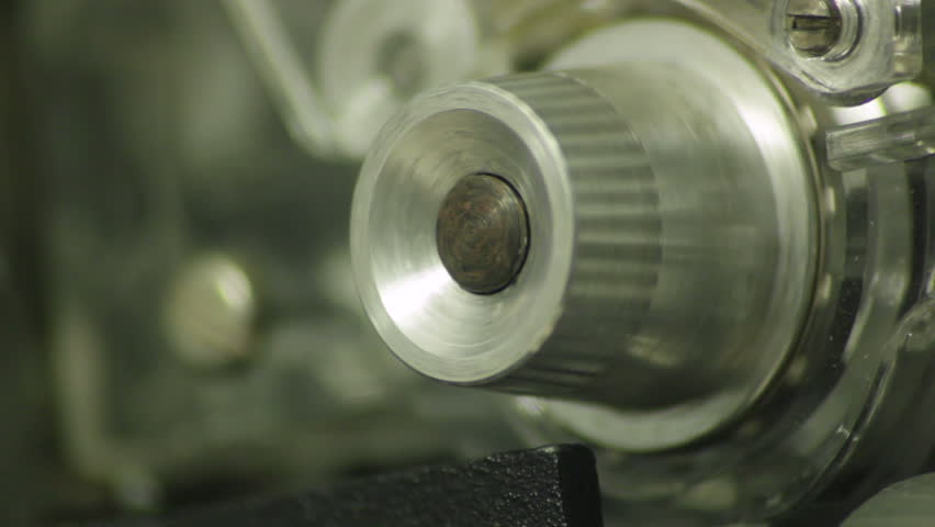 A film projector sprocket turns.