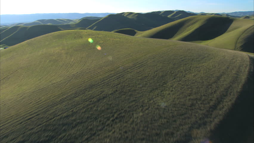 Aerial view of green hillside & rural farming areas