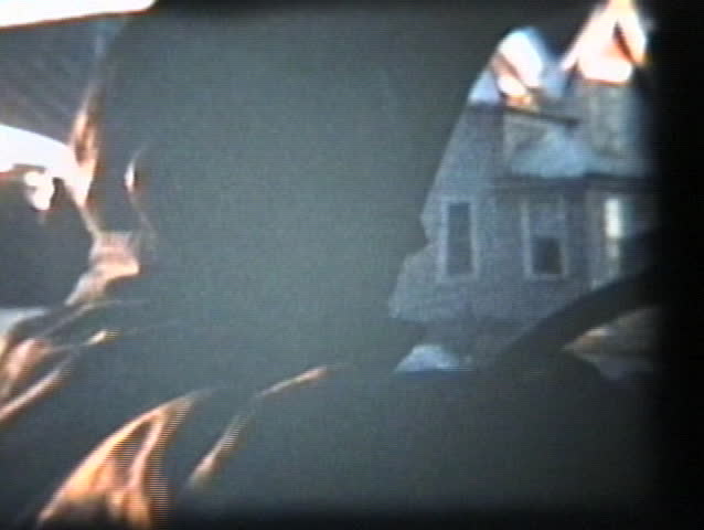A cool shot of young people sitting in a car smoking cigarettes and drinking but their faces are obscured by the sunlight.