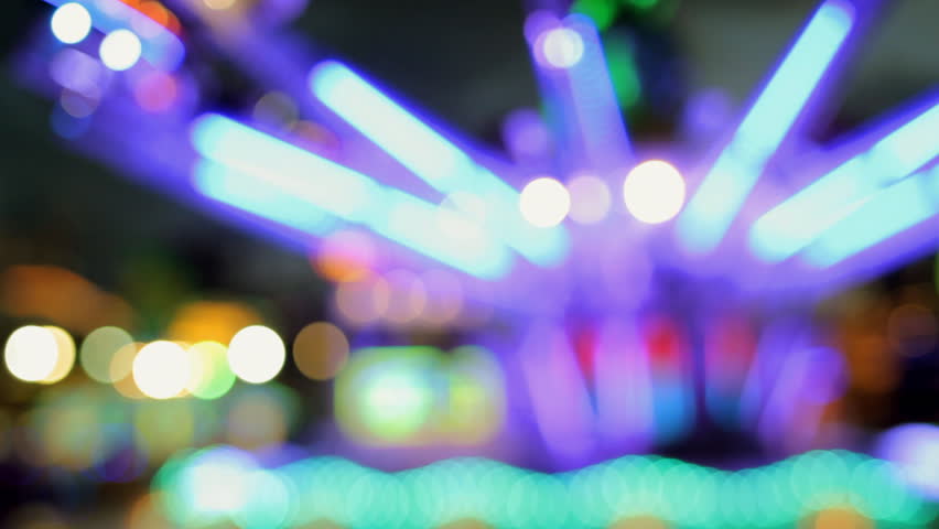 an amusement ride at a carnival or fair in barcelona spain, slightly blurred version