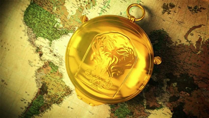 Retro gold compass opening on the old map