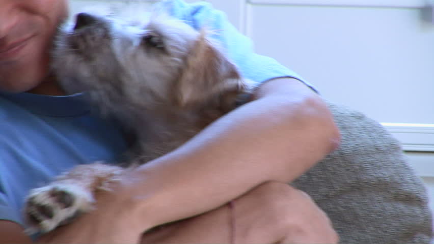Young Asian man playing with pet dog