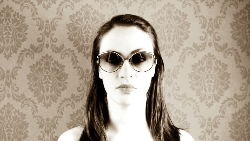 stop-motion of a pretty woman wearing different retro sunglasses
