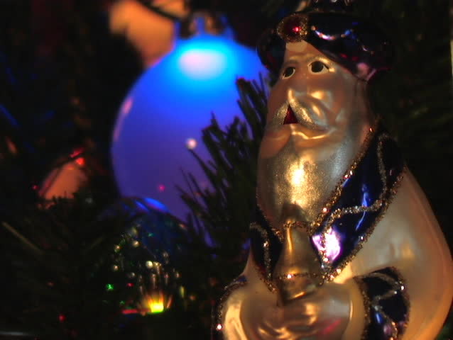 ORNAMENT HANGING ON A CHRISTMAS TREE DEPICTING ON OF THE THREE WISE MEN.