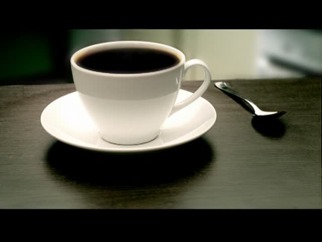 Hot Coffee ready for breakfast on a kitchen table. Smoke is seen.