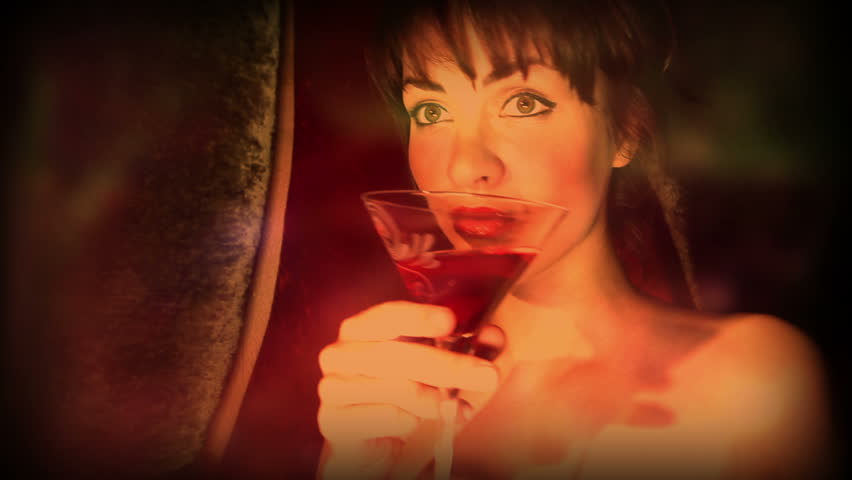 beautiful classic pinup girl in a VIP club drinking a cocktail