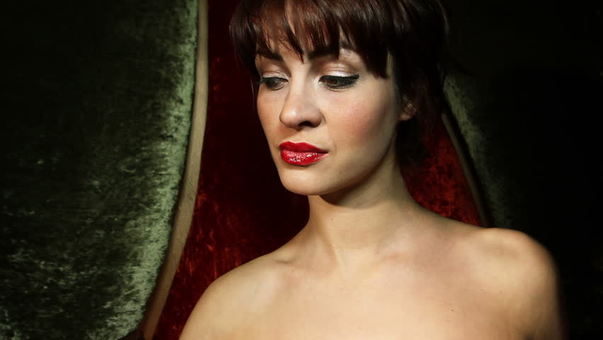 beautiful classic pinup girl in a VIP club drinking a cocktail