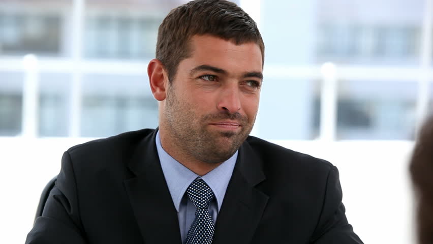 Interview between a businessman and a woman in an office