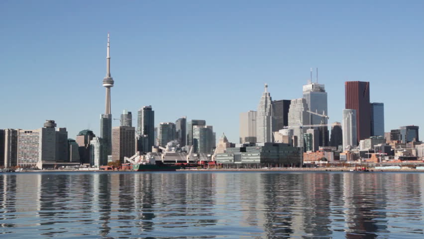 Toronto waterfront.  View of Toronto from the east. Sunny autumn day with glassy water. Tower crane rotates in the distance. Toronto, Ontario, Canada. 