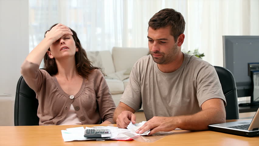 Couple studying their bills at home